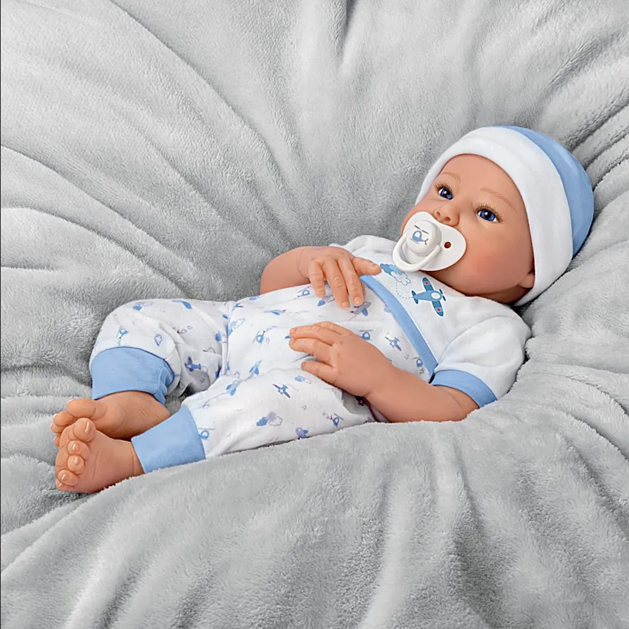 The Ashton - Drake Galleries New To The Crew Baby Boy Doll Weighted Poseable TrueTouch® Authentic Silicone with Helicopter Pacifier and Outfit by Michelle Fagan 18-inches